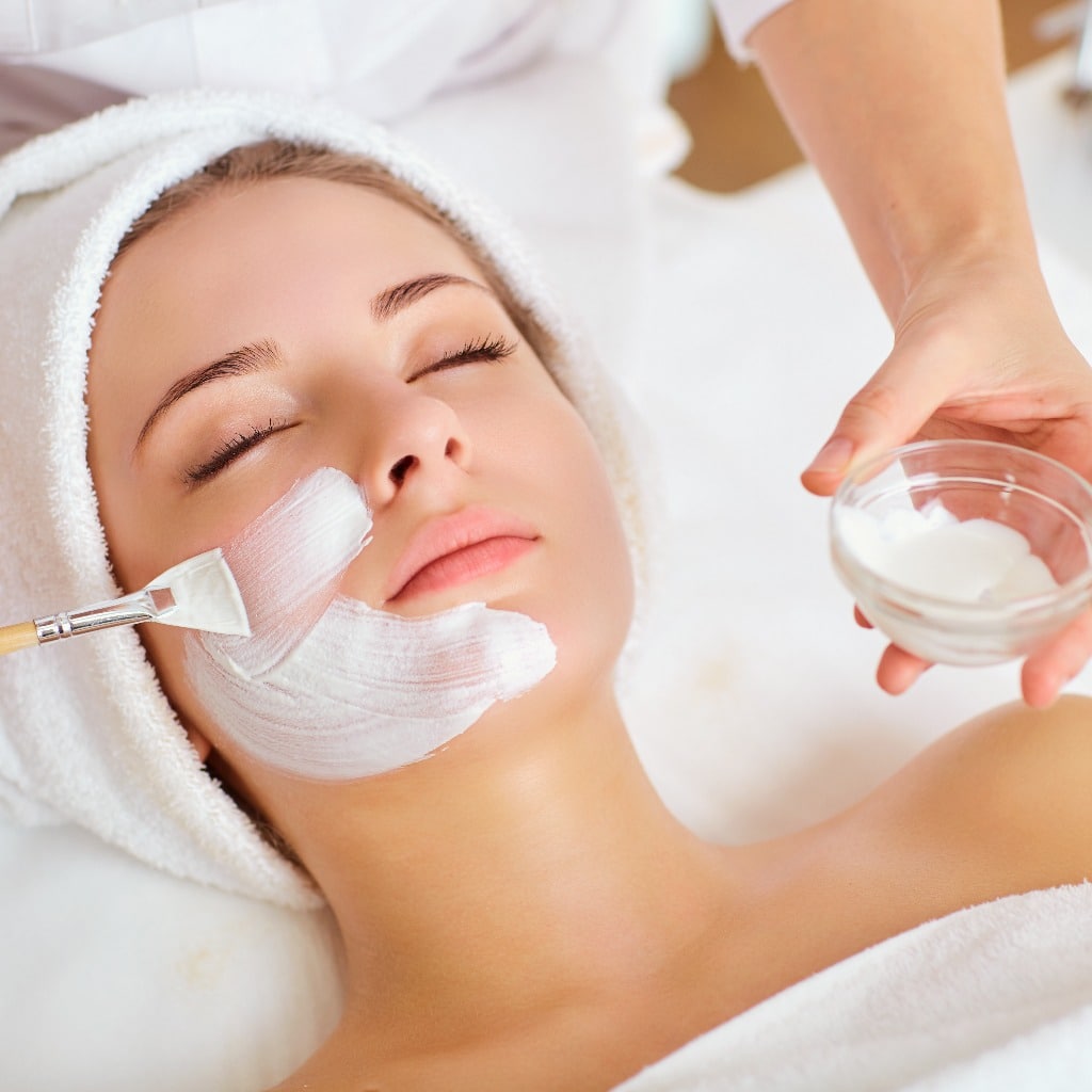 Woman in mask on face in spa beauty salon.